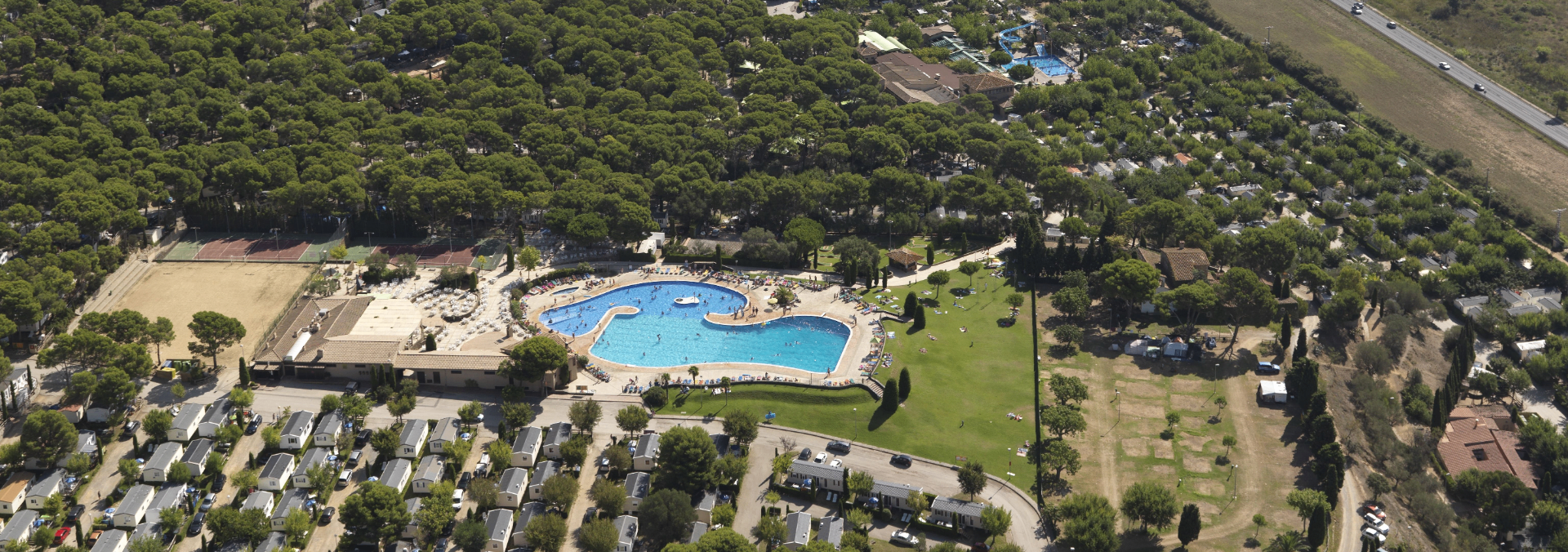 Vista aérea del Camping Natura Village Castell Montgrí — piscina y bungalows